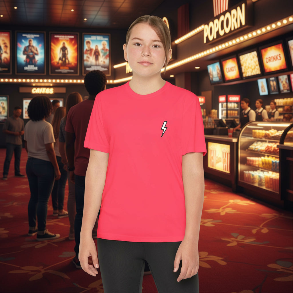 Person wearing a red t-shirt with a lightning bolt design in a movie theater.