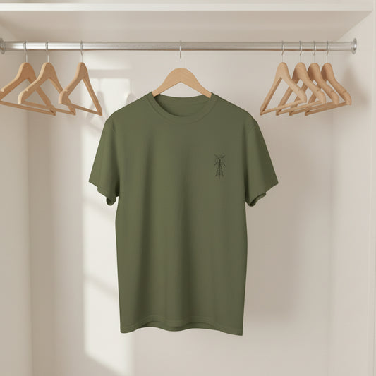 Green t-shirt with a small logo on a wooden hanger against a neutral background