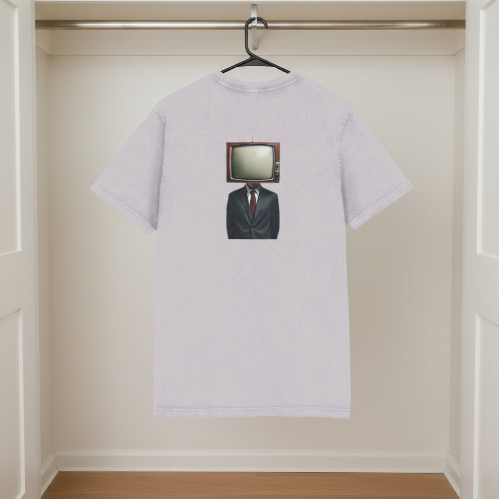 White t-shirt with a unique design of a television set in a suit on a hanger against a beige wall.