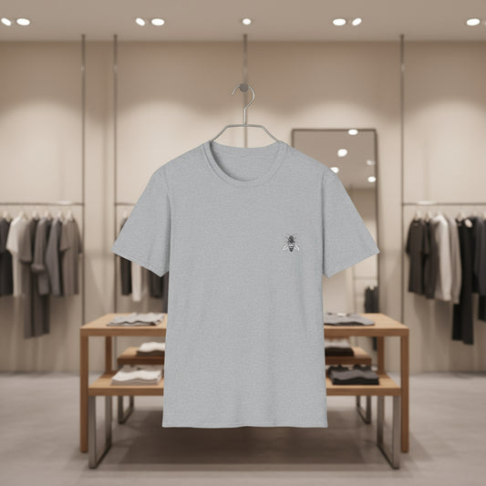 Gray t-shirt with a small logo on a hanger in a clothing store.