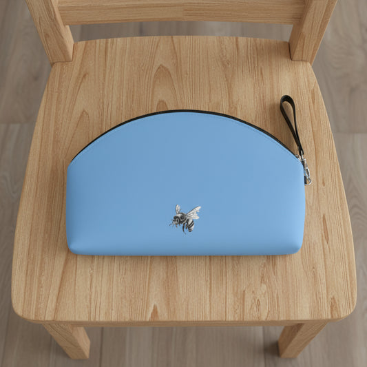 Blue pouch with a bee design on a wooden chair
