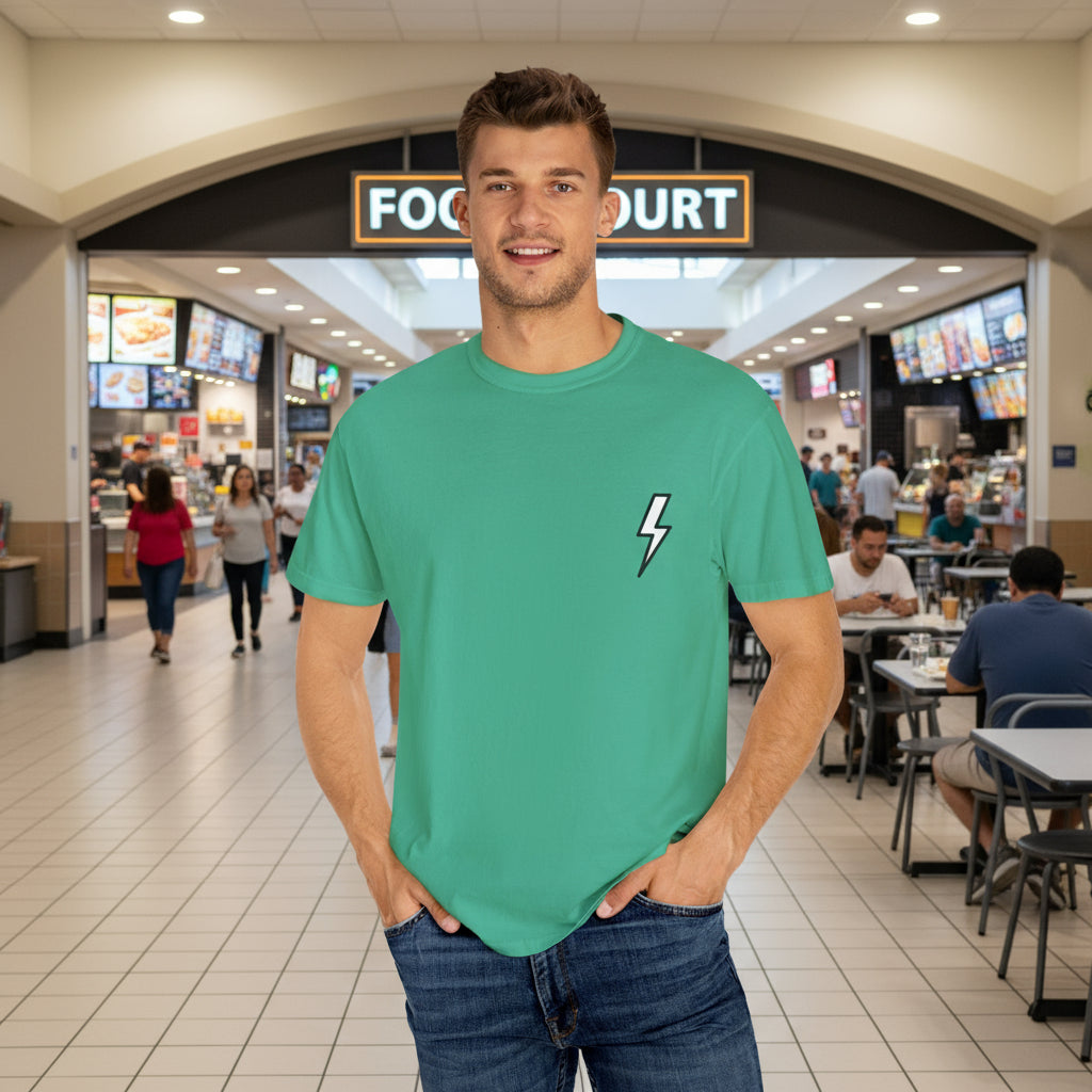 Man wearing a green t-shirt with a lightning bolt design on a white background