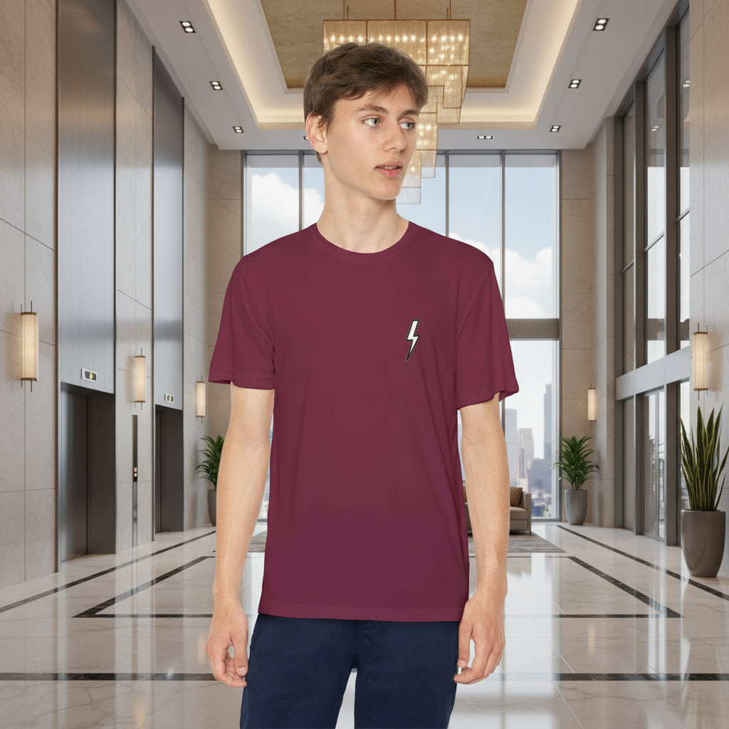 Person wearing a maroon t-shirt with a logo in a modern indoor setting