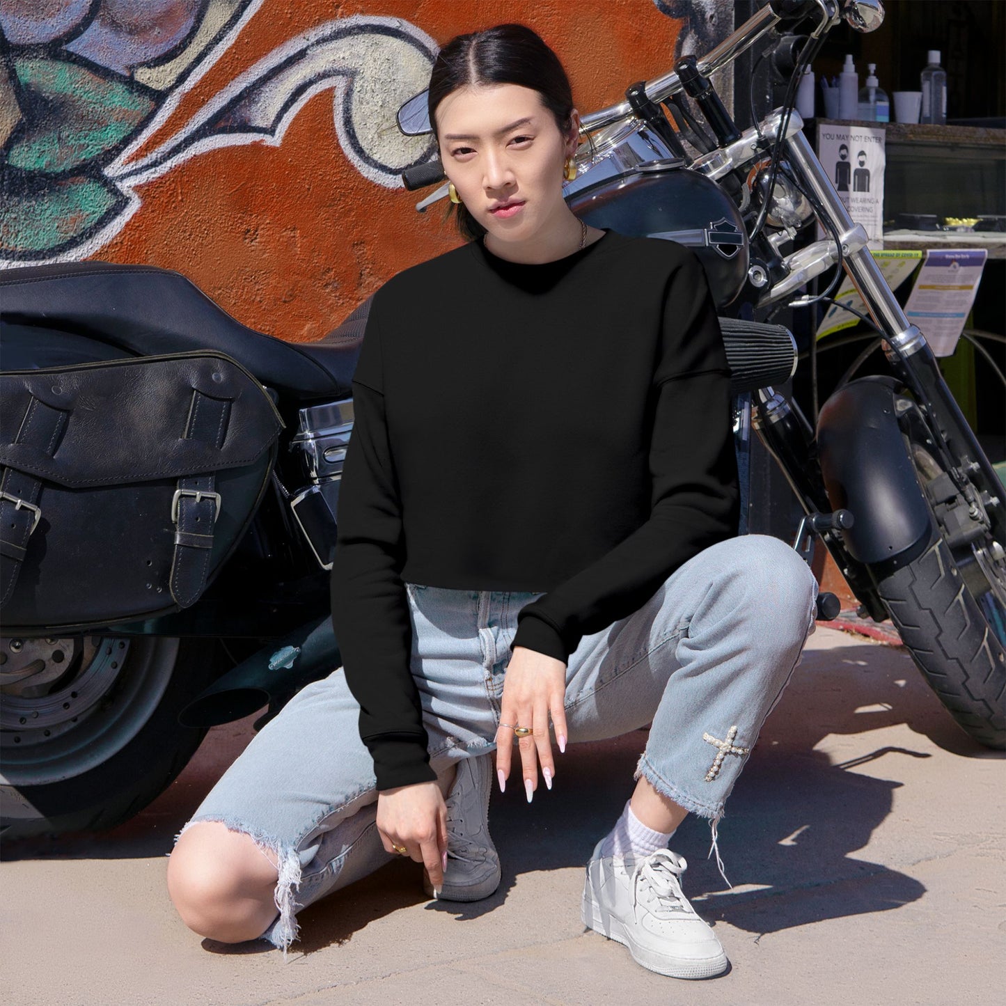 woman with black sweater in front of motorcycle 