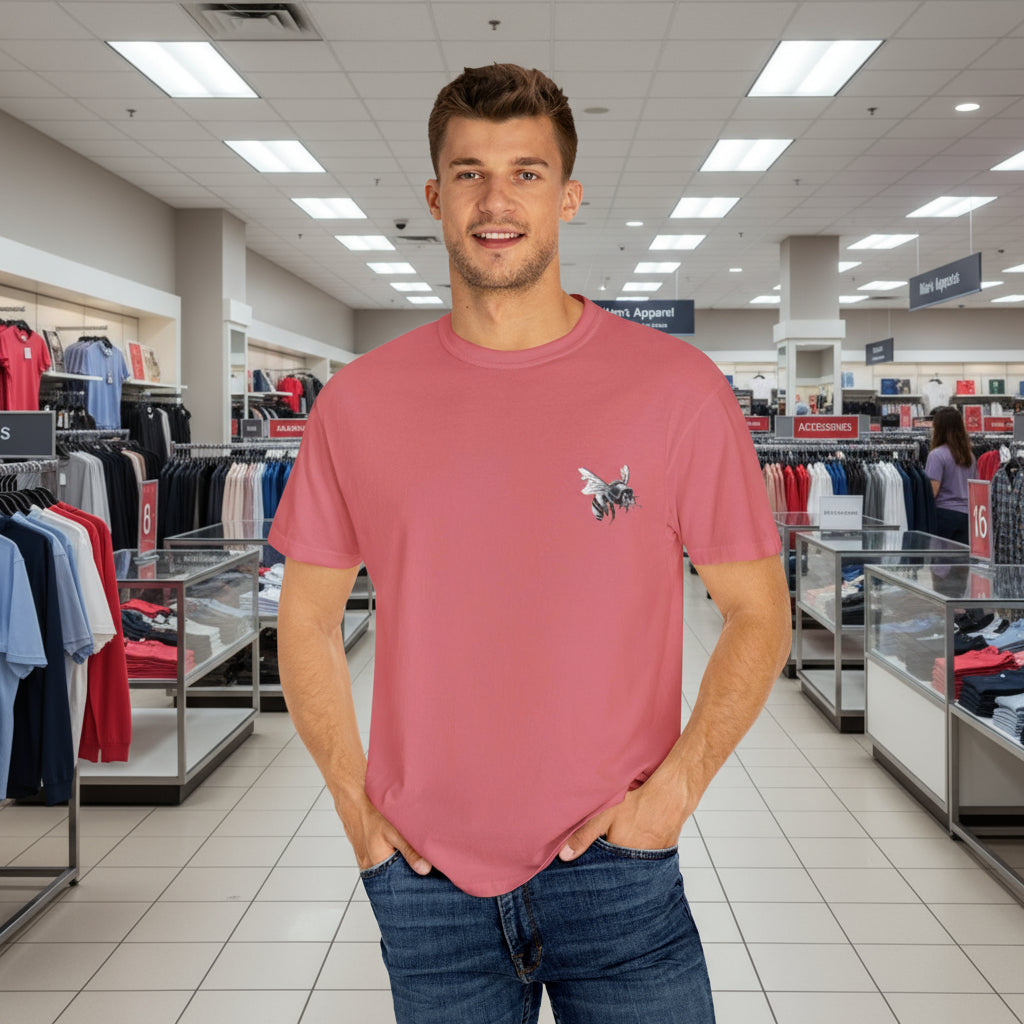 Man wearing a pink t-shirt with a small graphic in a clothing store