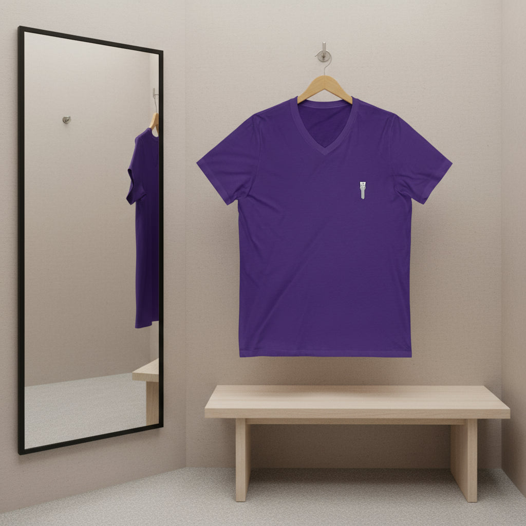 Purple t-shirt hanging on a hanger with a mirror reflecting the shirt.