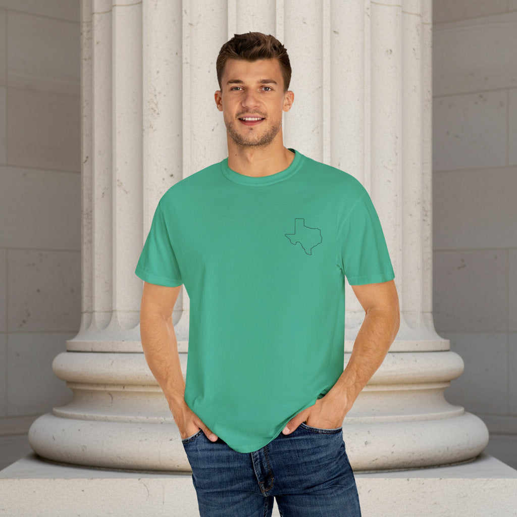 Man wearing a green t-shirt with a small logo on a white background