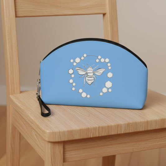 Blue pouch with bee design on a white background