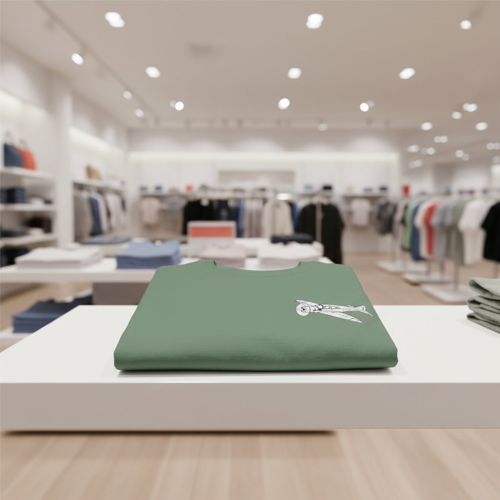 Folded green t-shirt with a white airplane design on a white background