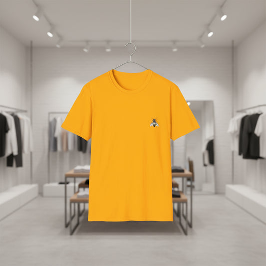 Yellow t-shirt with a small logo on a hanger against a blurred clothing store background