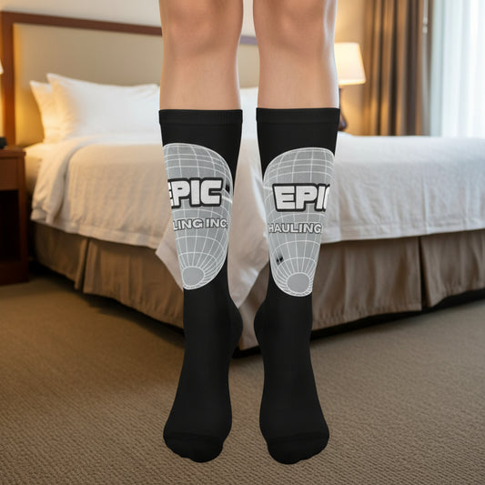 Black socks with 'EPIC' branding worn indoors, likely in a bedroom.