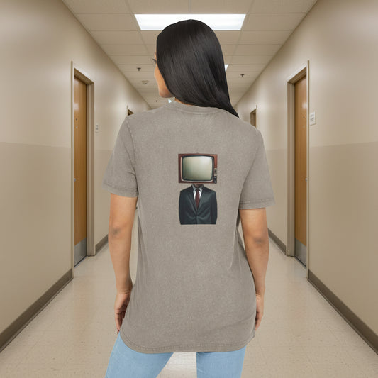 Person wearing a beige t-shirt with a graphic design on the back, standing against a white background