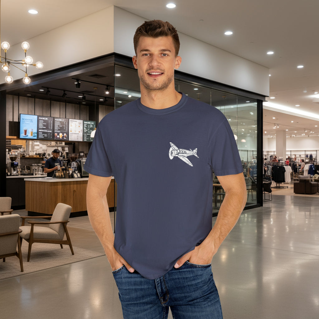 Man wearing a navy blue t-shirt with a logo in a modern indoor setting