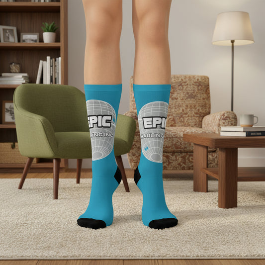 Person wearing blue socks with 'EPIC' branding in a living room setting